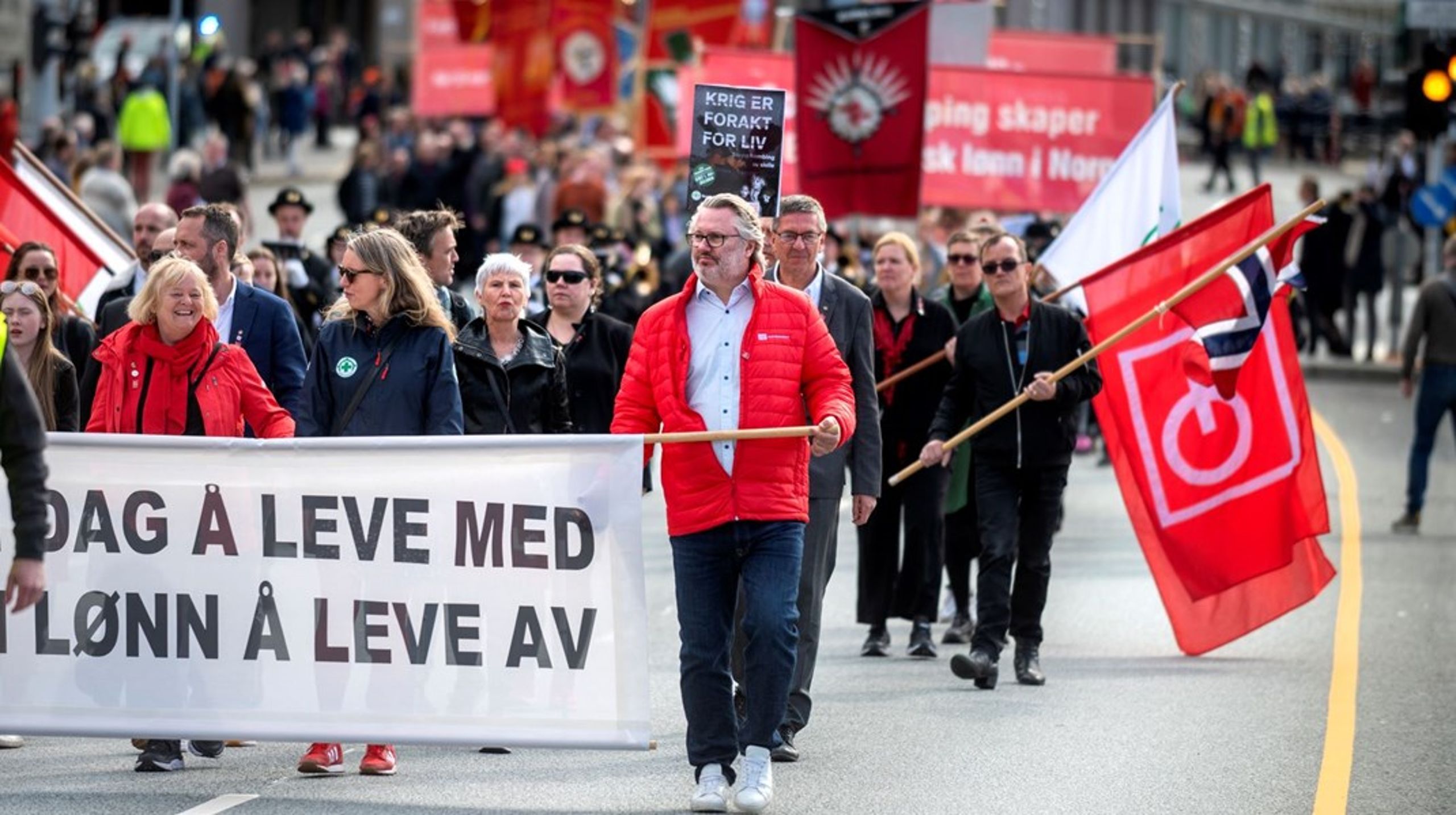 Leder i Fellesorganisasjonen Mimmi Kvisvik (til venstre i bildet) marsjerer bak en likelønnsfane på 1. mai i fjor. Denne uken er det både likelønnsdag og landsmøte i Fellesorganisasjonen.